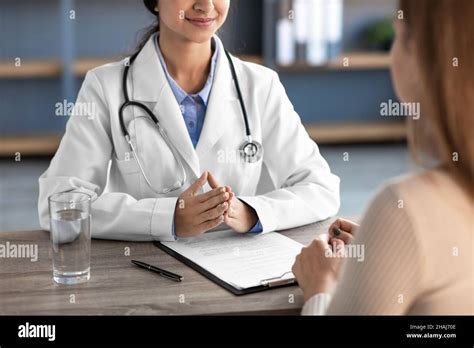 happy young indian female doctor  white coat  stethoscope