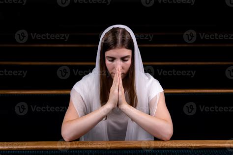 A Christian girl praying with humble heart in the church 2462407 Stock