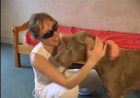 Girl with glasses teaches big dog how to fuck her