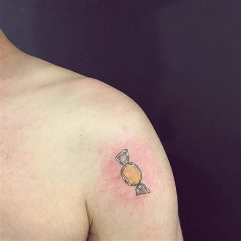 Lemon candy tattoo located on the shoulder.