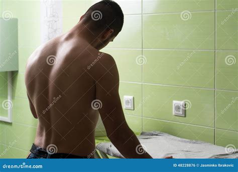 Naked Man Ironing Clothes in a Utility Room Stock Photo - Image of