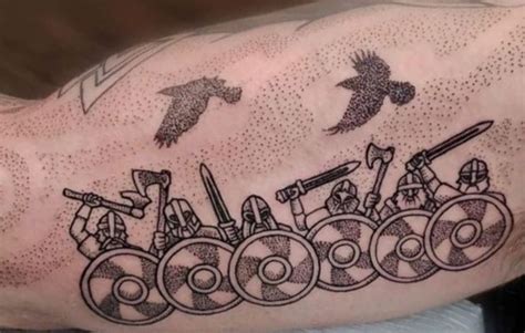a man's arm with an old timey tattoo on it, and birds flying above