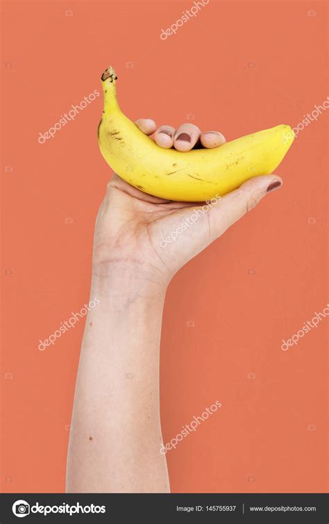 hand holding banana stock photo  crawpixel