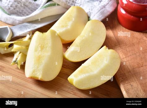 fuji apple sliced  wedges   cutting board stock photo alamy