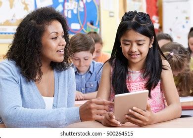 teacher helping group elementary school children stock photo edit