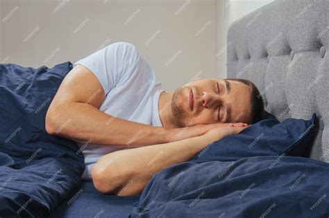 Premium Photo | Top view of a handsome young man sleeping comfortably ...