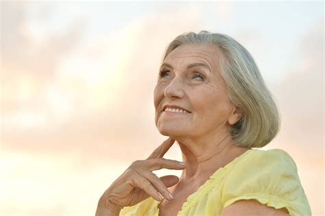 Download Beautiful Older Woman Yellow Top Wallpaper | Wallpapers.com