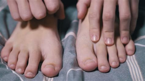 Close Up, Child Massages His Tired Feet with His Hands on the Bed in ...