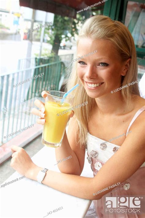year  girl sitting   cafe drinking orange stock photo