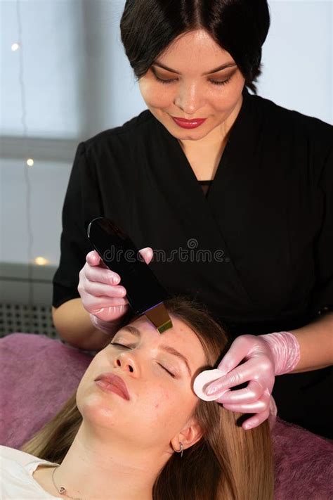 woman receiving ultrasonic facial exfoliation professional beautician