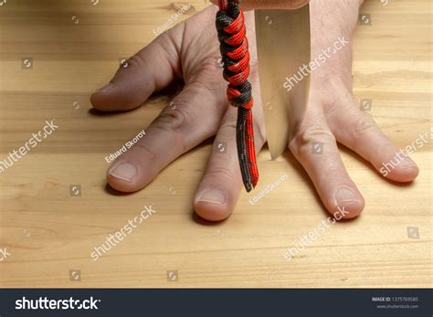 dangerous game blade knife  fingers stock photo