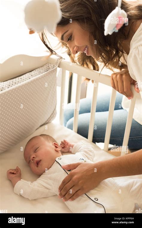 Mother putting baby to sleep at the crib Stock Photo - Alamy