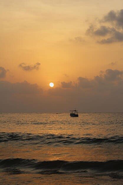 Premium Photo | Sunset at the sea with a boat going