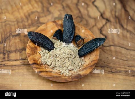 brown dutch tonka bean on olive wood Stock Photo - Alamy