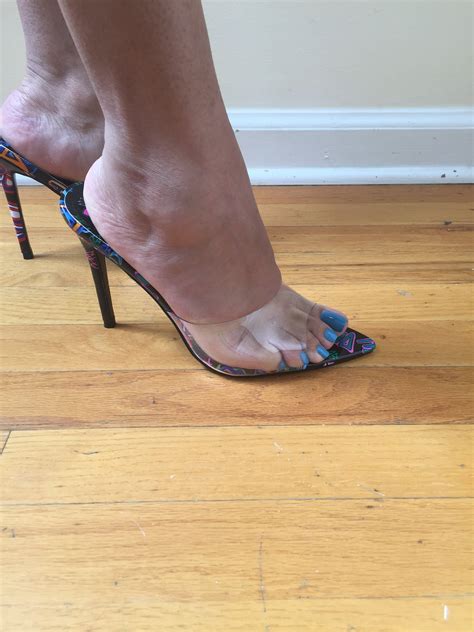 Clear open toe slip on high heel with graffiti accent bottom. Simple