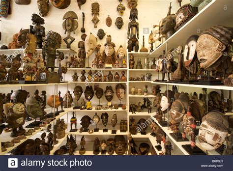 Wooden masks and curios for sale in a Long Street curio shop in Cape ...