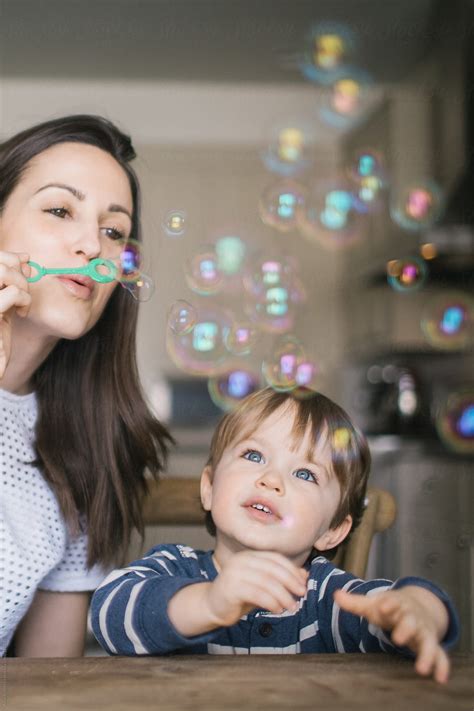 "Mom Blowing Bubbles With Her Son" by Stocksy Contributor "A Model