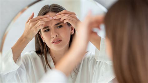 Have Annoying Forehead Acne? Here's What May Be Causing It