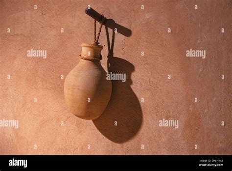 handmade clay water jar hanging  traditional village house stock