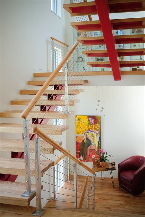 Beautiful open riser wooden staircase with a cable railing system ...