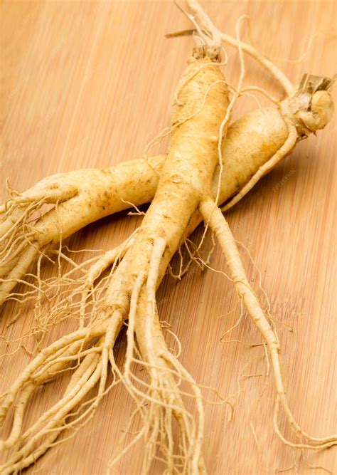Premium Photo | Fresh ginseng on the wooden background