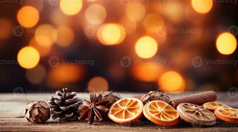 Traditional Christmas spices and dried orange slices on holiday light