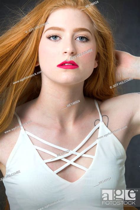 Head and shoulders portrait of beautiful young woman with bountiful red ...