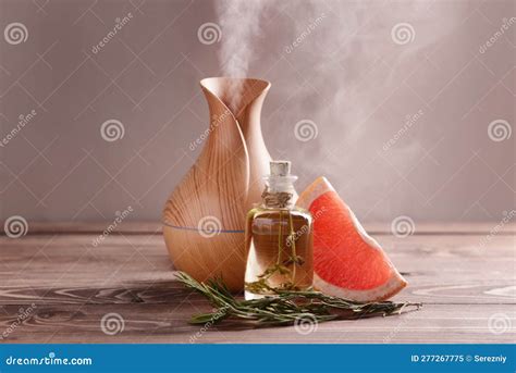 Aroma Oil Diffuser, Rosemary and Grapefruit on Table Stock Image ...