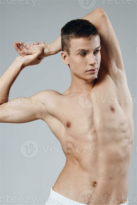 portrait of a half-naked athlete on a gray background close-up 23762160