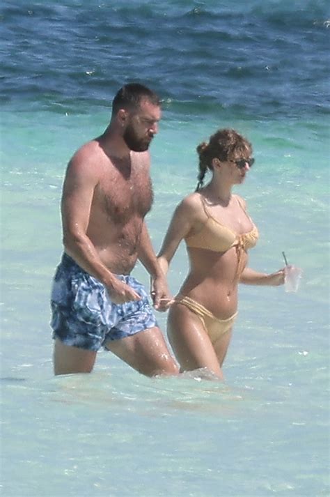 Travis Kelce protectively wraps his arms around Taylor Swift while