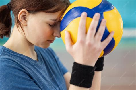 Premium Photo | Female volleyball player on court with ball in her ...