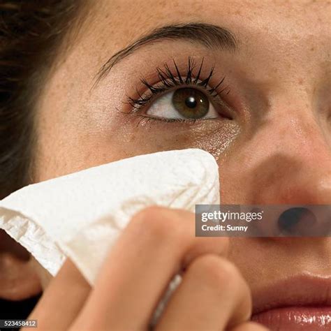 wiping tears woman stock  high res pictures  images