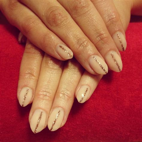 Almond shaped nails with nude color and glitter by Pampered Pointers