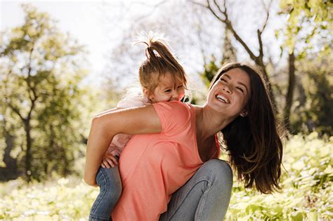 Cheerful Single Mother Having Fun With Her Small Daughter In Nature