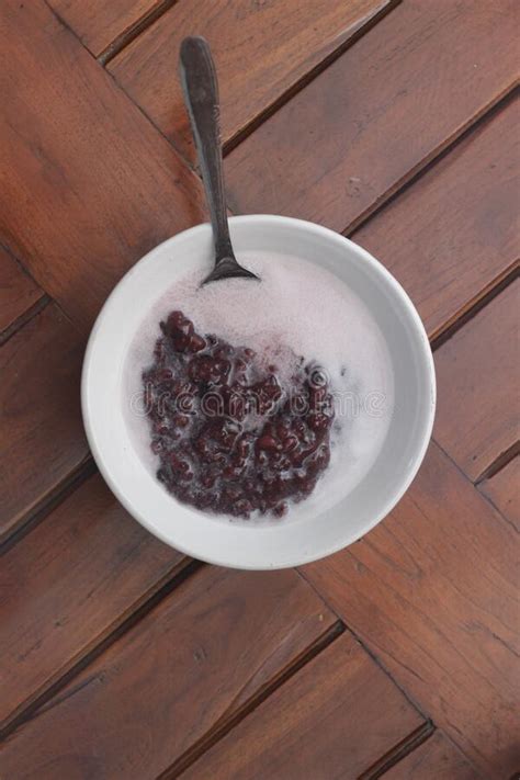 A Bowl of Black Sticky Rice Porridge with Coconut Milk Stock Photo ...