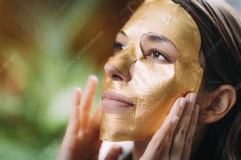 Gold face mask treatment - Stock Image - F037/5404 - Science Photo Library