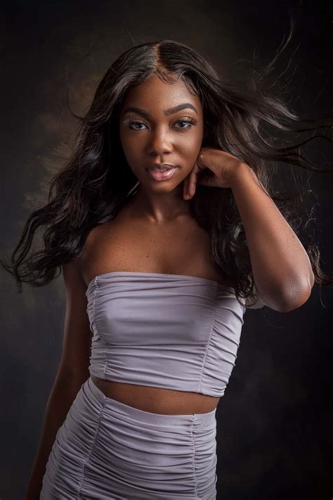 Download Confidence in Her Beauty - A Stunning Black Woman in Purple