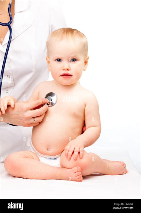 Pediatrician examines little baby girl using a stethoscope to listen to baby's chest checking ...