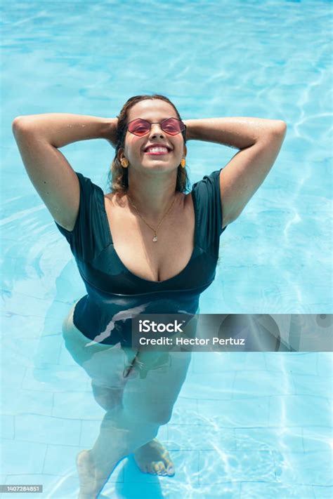 curvy woman enjoying  pool stock photo  image