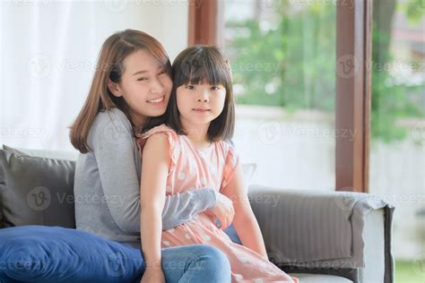 Asian mother feel hapiness during hug her cute daughter with love and