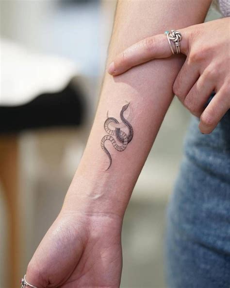 Snake and moon tattoo placed on the wrist. | Snake tattoo design, Small ...