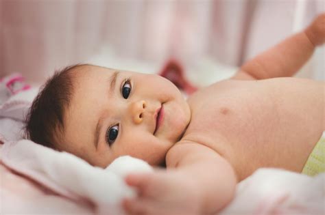 baby lying  pink bed  stock photo