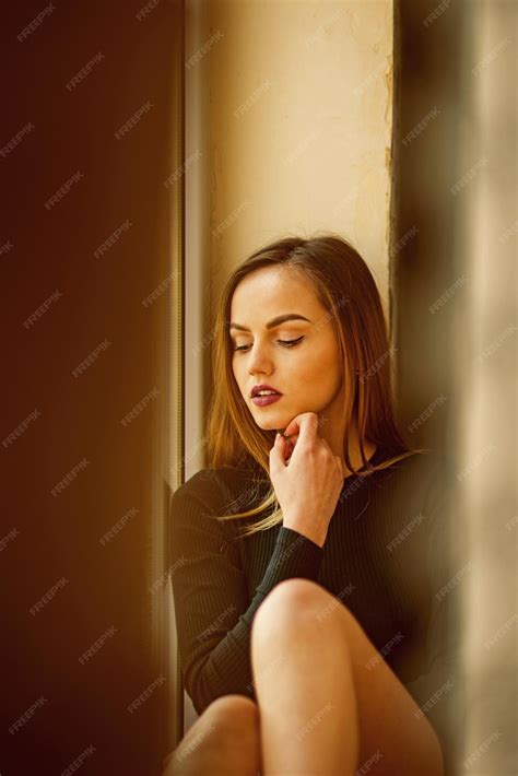 Premium Photo | Woman with makeup on pretty face sit at wall woman