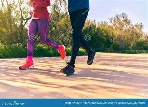 Two persons running stock image. Image of couple, outdoor - 215779653