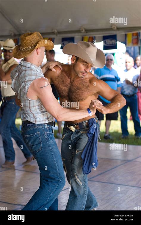 gay couple dancing to country and western music at rodeo event Stock ...