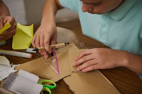 Young Student Engaging in Crafts with Recycled Cardboard and Measuring Tools Stock Image - Image ...
