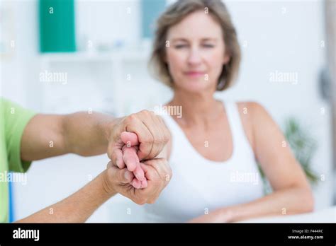 Doctor examining his patients hand Stock Photo - Alamy