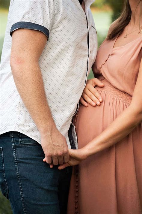 Download Sweet Pregnant Couple Holding Hands Wallpaper | Wallpapers.com