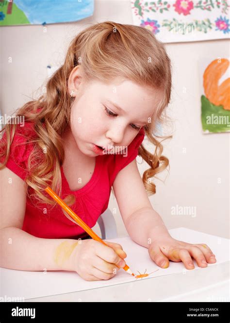 Child with color pencil draw in preschool Stock Photo - Alamy