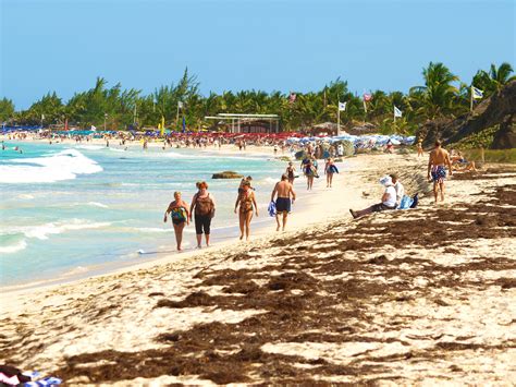 ST MARTIN ISLAND** | People walking along Orient Beach | By: gobucks2